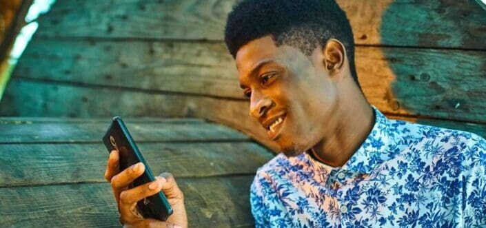 An amused guy reading a text message.