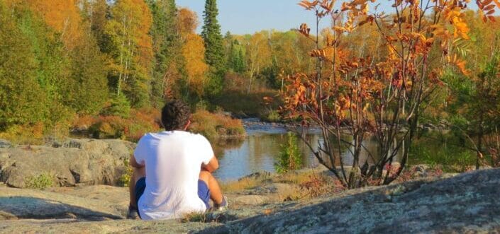 Man sitting beneath a river