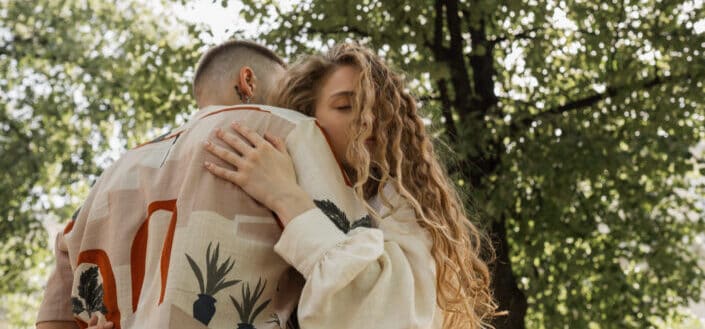 Couple embracing under a tree