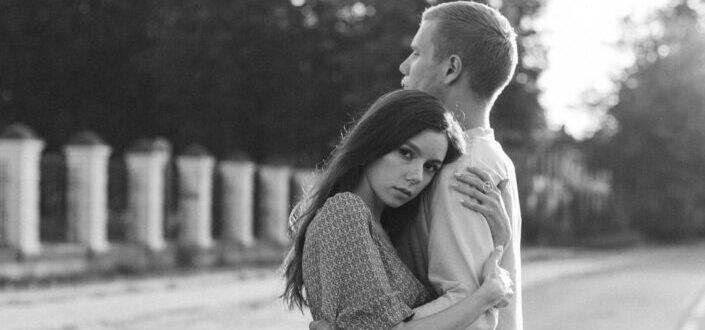 couple embracing each other on the street