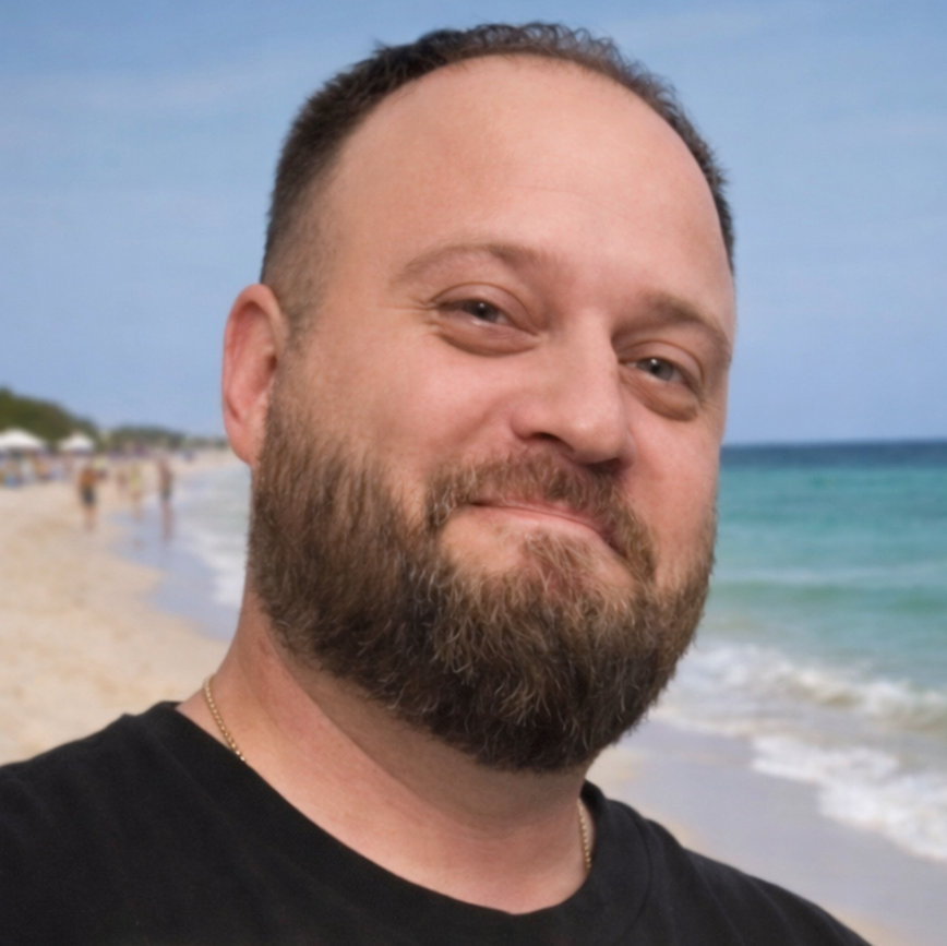 Man's face with beard standing on beach