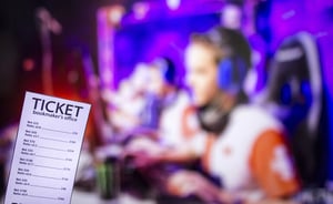 Betting ticket with an esports match blurred in the background