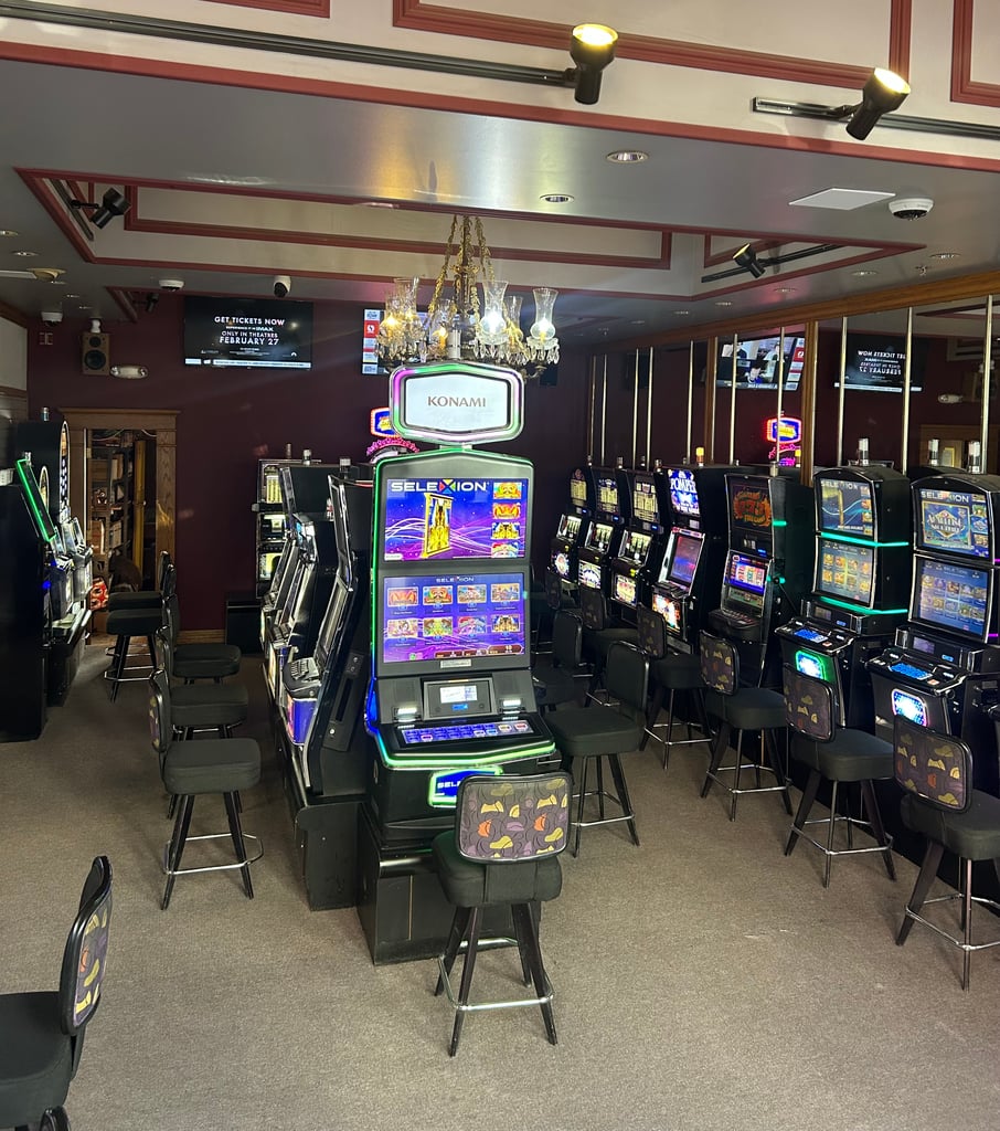 Slot machines and chairs in a hall.