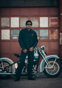 Man wearing Harley-Davidson Dickies outfit with a bike behind him