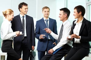 Business team networking over coffee, illustrating a collaborative corporate culture that supports sustainable development.