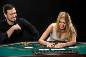 A couple sitting at a casino table in Las Vegas