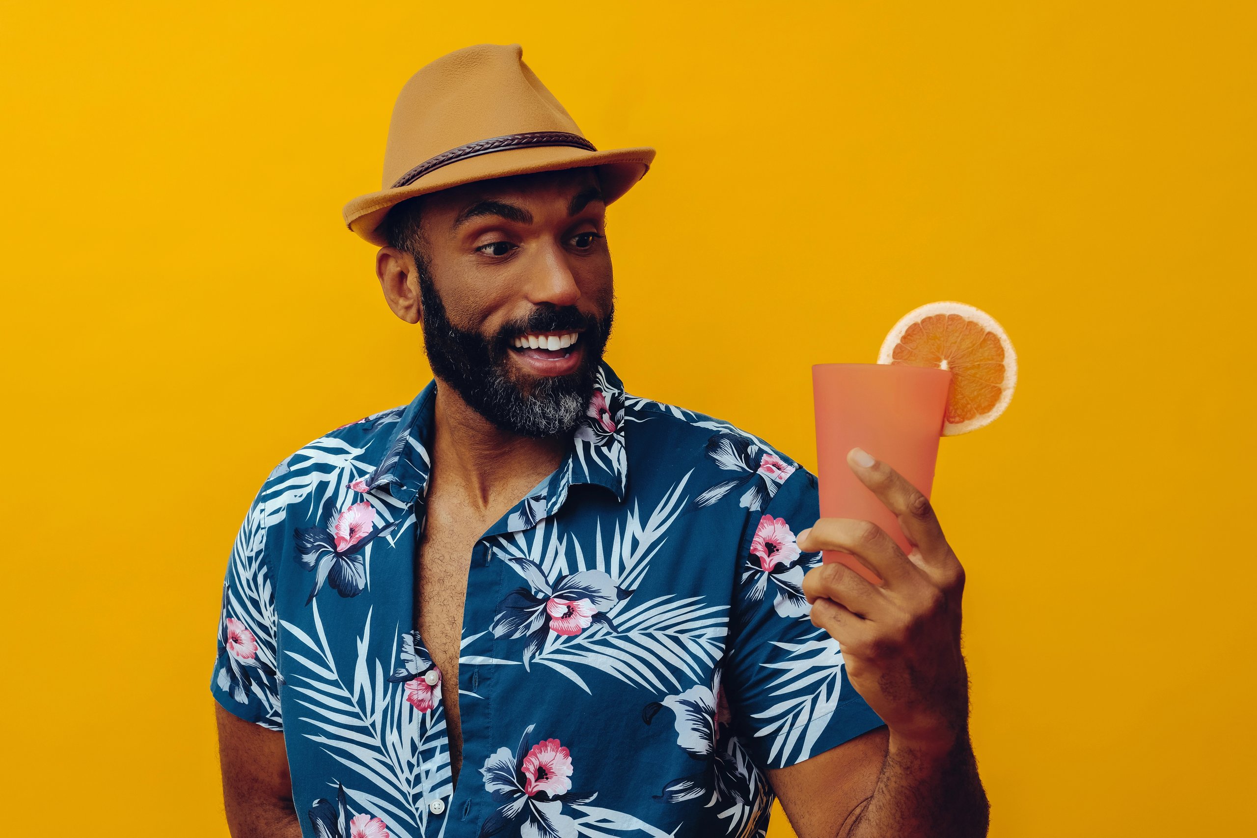 Man in stylish shirt looking at non-alcoholic drink