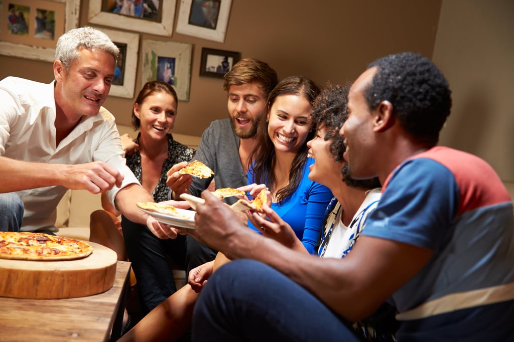 group of people sharing snacks on a couch