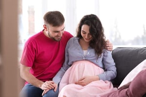 A man and woman sitting together, showing emotional support and partnership during recovery after a birth injury.