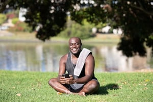 Man taking a break from his phone outside in a park after spending time online